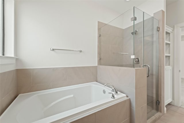 bathroom featuring tile patterned floors and separate shower and tub