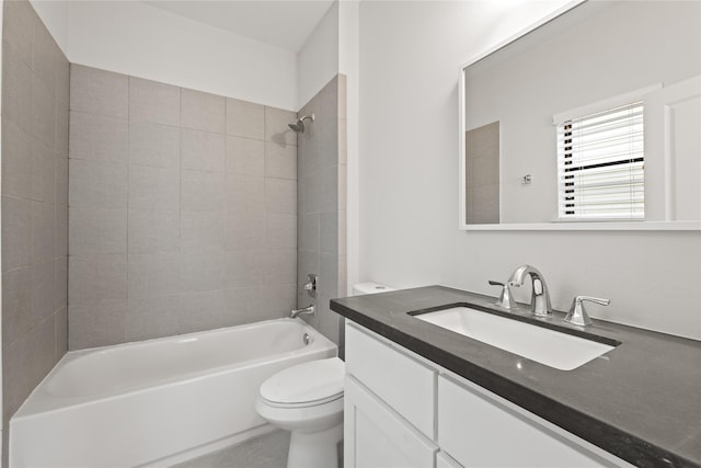 full bathroom featuring tiled shower / bath combo, vanity, and toilet