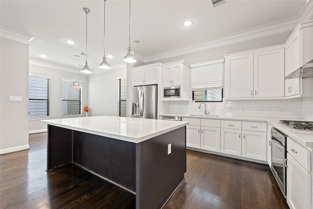 kitchen featuring a kitchen island, appliances with stainless steel finishes, pendant lighting, white cabinetry, and dark hardwood / wood-style flooring