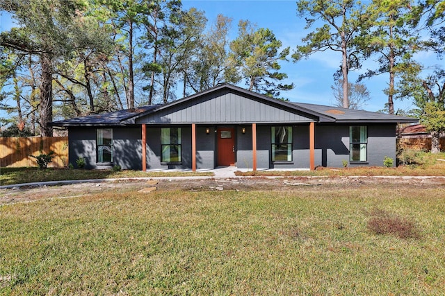 ranch-style home featuring a front yard