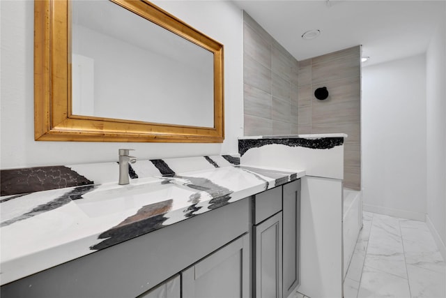 bathroom with vanity and a bath