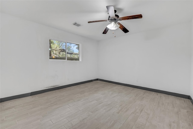 empty room featuring ceiling fan and light hardwood / wood-style floors