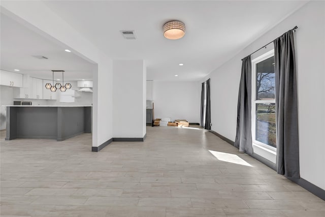 corridor with light hardwood / wood-style flooring