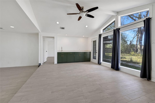 unfurnished room featuring vaulted ceiling with beams and ceiling fan