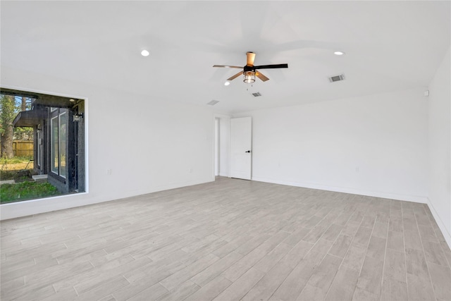 empty room with ceiling fan and light hardwood / wood-style flooring