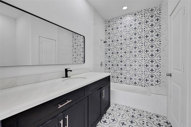 bathroom featuring tile patterned flooring, vanity, and washtub / shower combination