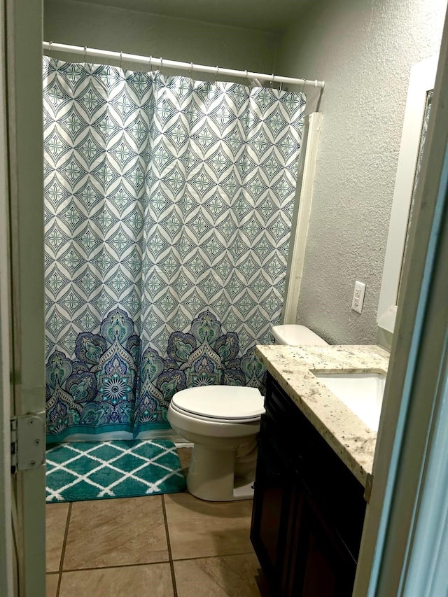 bathroom featuring tile patterned floors, toilet, and vanity