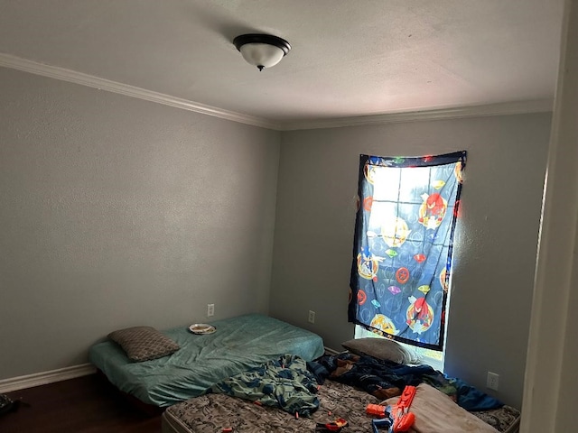 bedroom with crown molding and hardwood / wood-style flooring