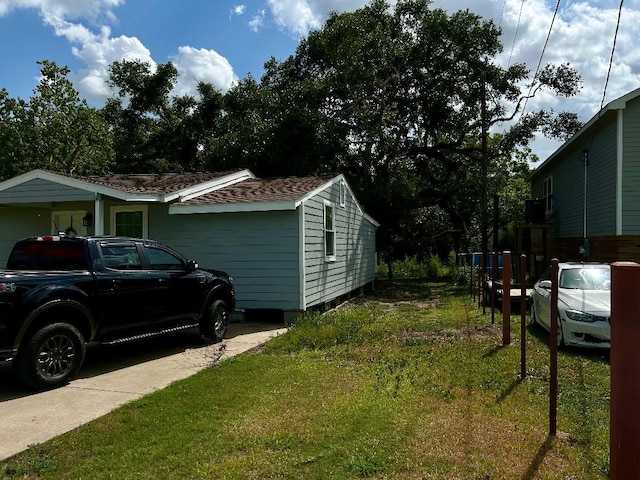 view of side of home featuring a yard