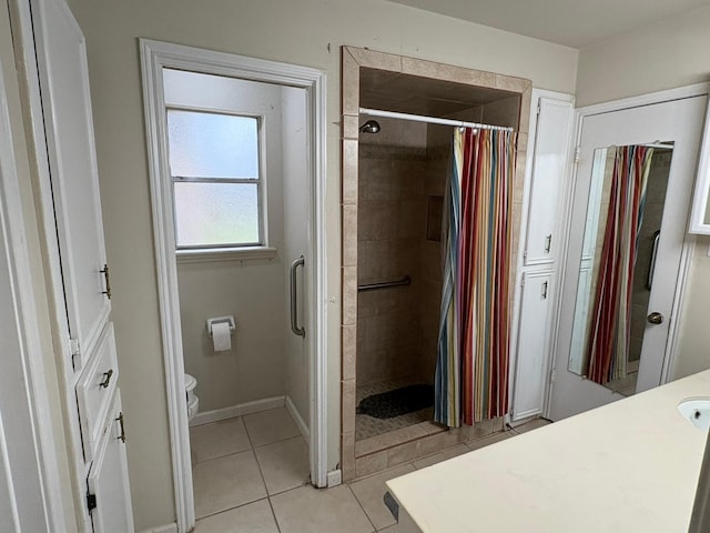 bathroom featuring curtained shower, tile patterned floors, vanity, and toilet