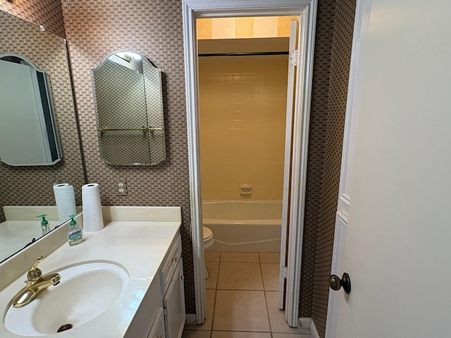 full bathroom with toilet, vanity, tile patterned flooring, and tiled shower / bath