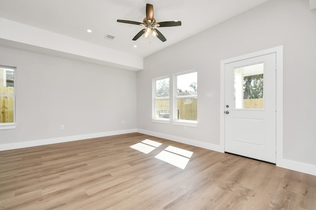 foyer entrance with ceiling fan and light hardwood / wood-style floors