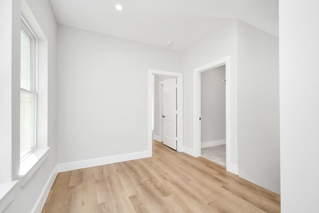 empty room featuring a wealth of natural light and light wood-type flooring