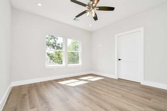 empty room with ceiling fan and light hardwood / wood-style flooring