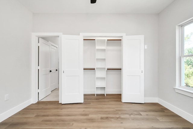 unfurnished bedroom featuring ceiling fan and light hardwood / wood-style flooring