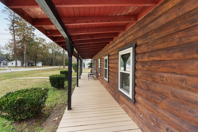 wooden deck with a lawn