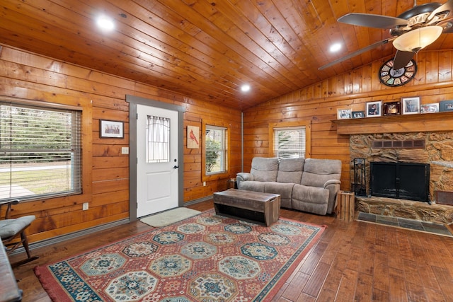 living room with ceiling fan, a healthy amount of sunlight, vaulted ceiling, and hardwood / wood-style floors