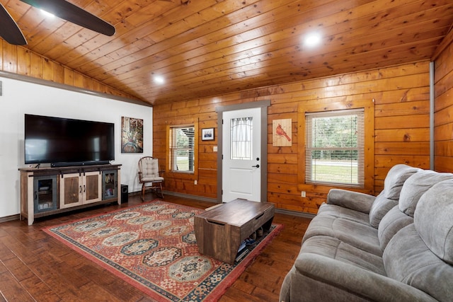 living room with ceiling fan, a wealth of natural light, wood walls, and wooden ceiling