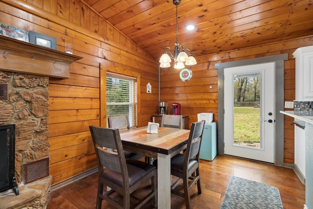 dining room featuring vaulted ceiling, wooden ceiling, a chandelier, and hardwood / wood-style flooring