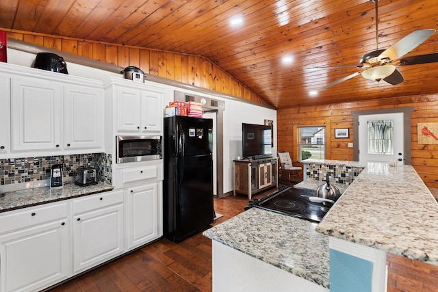 kitchen featuring decorative backsplash, light stone countertops, white cabinets, and black appliances