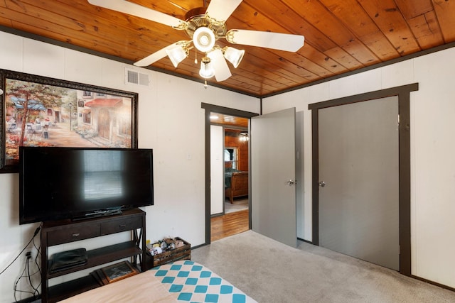 carpeted bedroom featuring ceiling fan and wood ceiling