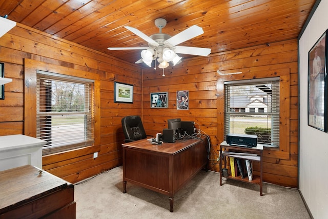 carpeted office space with ceiling fan, wood ceiling, and wood walls