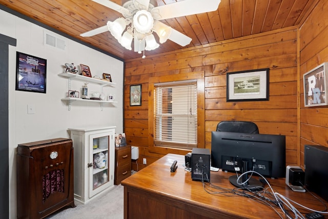 office space with wooden ceiling, light colored carpet, wood walls, and ceiling fan