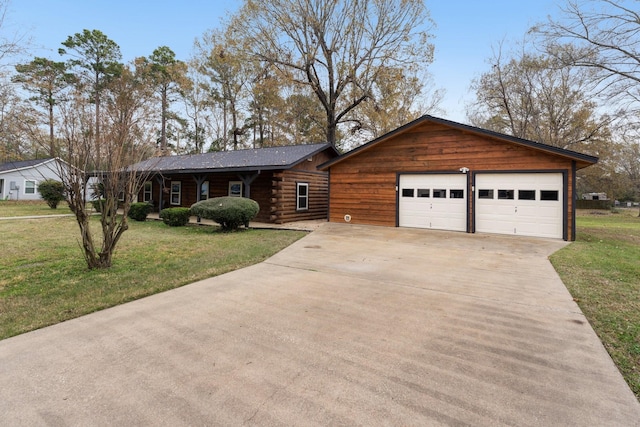 view of front of house with a garage and a front yard