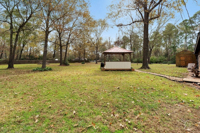 view of yard featuring a gazebo and a storage shed