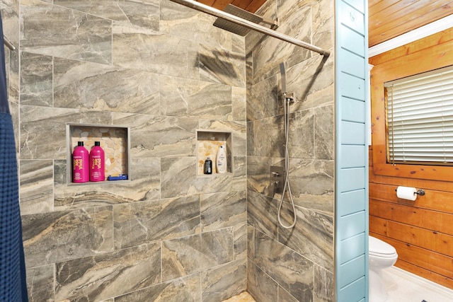 bathroom featuring curtained shower, toilet, and wooden walls