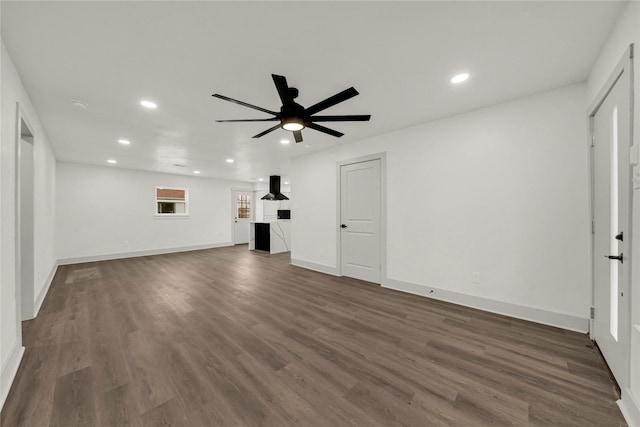 unfurnished living room with ceiling fan and dark hardwood / wood-style floors