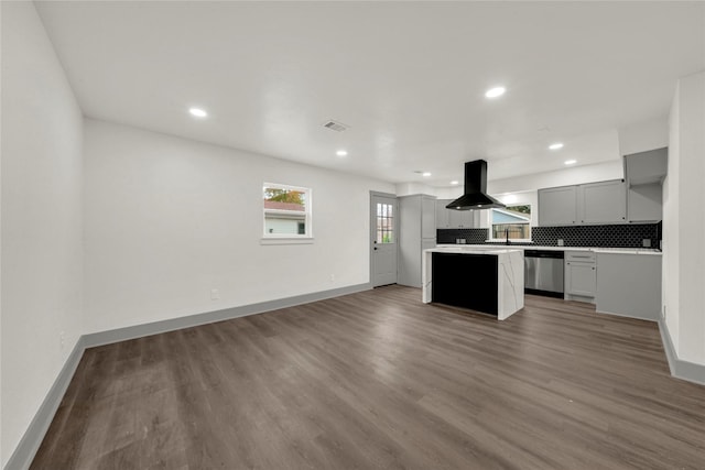 kitchen featuring island range hood, gray cabinetry, dark hardwood / wood-style flooring, stainless steel dishwasher, and a center island