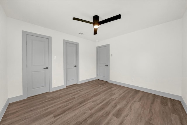 unfurnished bedroom with ceiling fan and hardwood / wood-style flooring