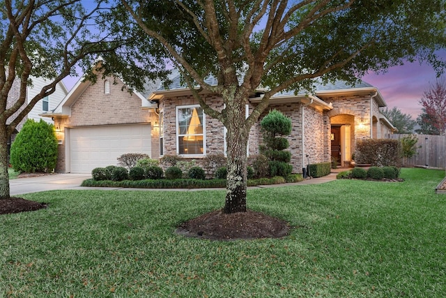 view of front of home featuring a garage and a lawn