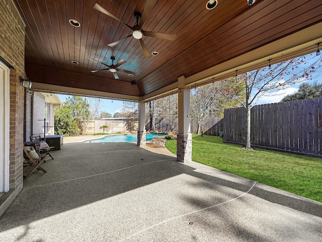 view of patio / terrace featuring ceiling fan and a fenced in pool