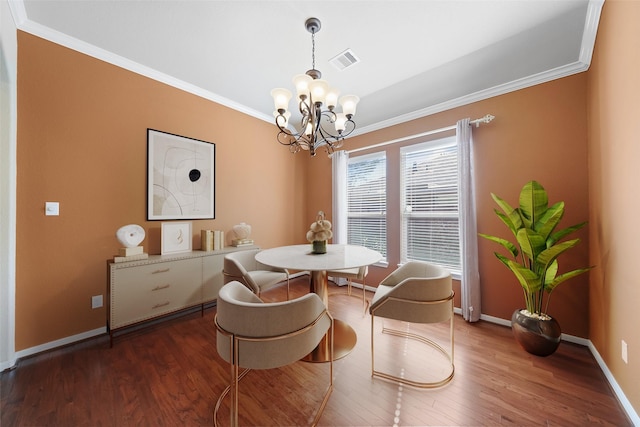 dining area with dark hardwood / wood-style flooring, a notable chandelier, and ornamental molding