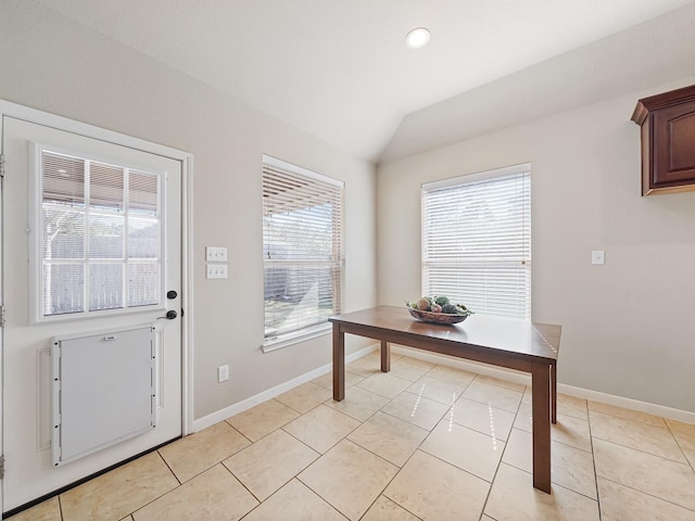 interior space with lofted ceiling and light tile patterned floors