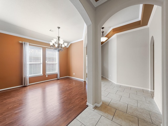 interior space with a notable chandelier, ornamental molding, and light tile patterned flooring