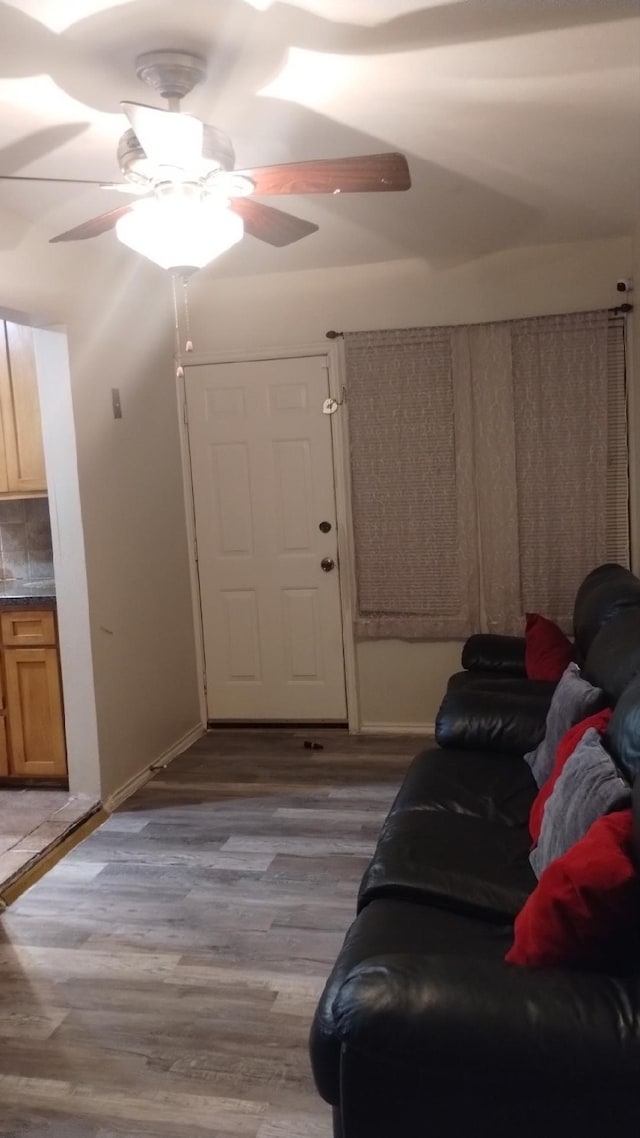 living room with ceiling fan and light wood-type flooring