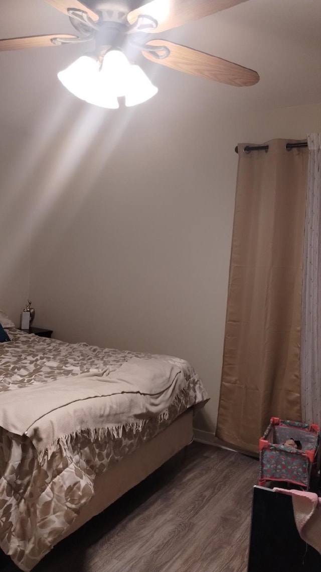 bedroom with dark wood-type flooring and ceiling fan