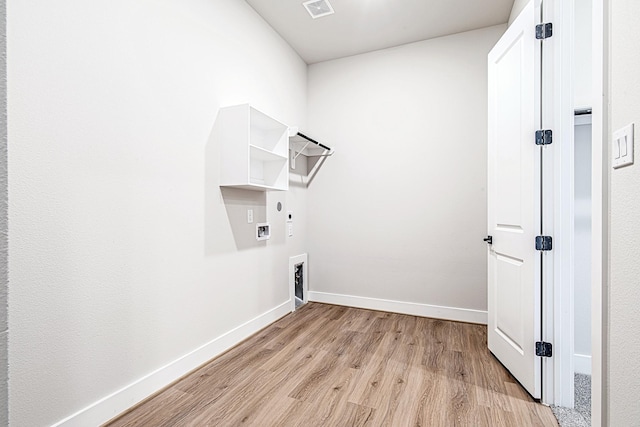 laundry room with hookup for a washing machine, hookup for an electric dryer, and light wood-type flooring