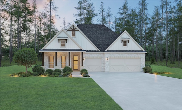 view of front facade featuring a garage, a yard, and covered porch