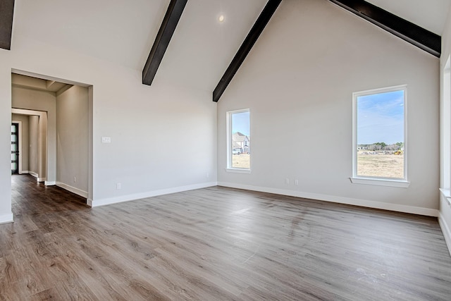 interior space with beamed ceiling, light hardwood / wood-style flooring, and high vaulted ceiling