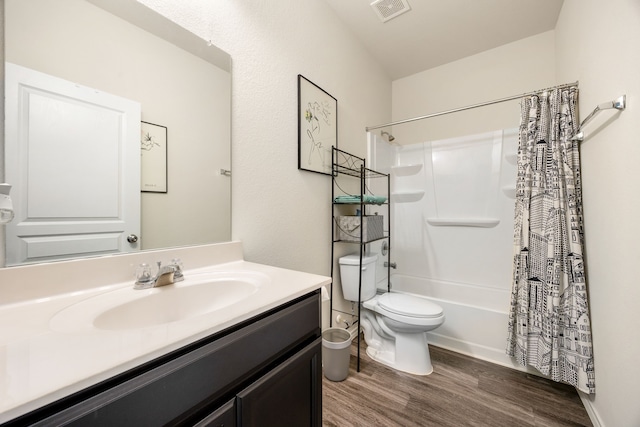 full bathroom with toilet, vanity, shower / bath combo with shower curtain, and hardwood / wood-style flooring