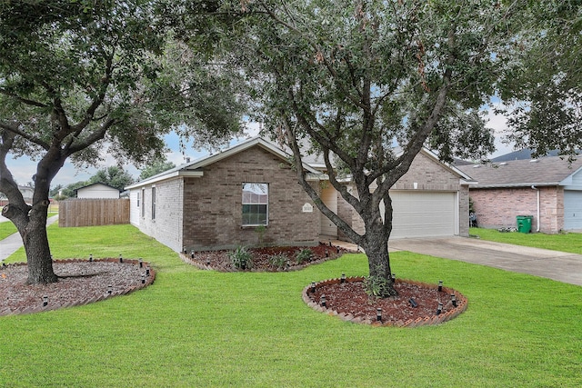 view of front of house with a front yard and a garage