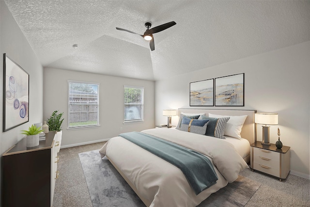 bedroom featuring ceiling fan, a textured ceiling, carpet floors, and vaulted ceiling