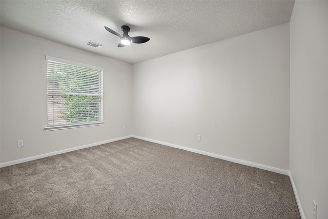 carpeted spare room with a textured ceiling