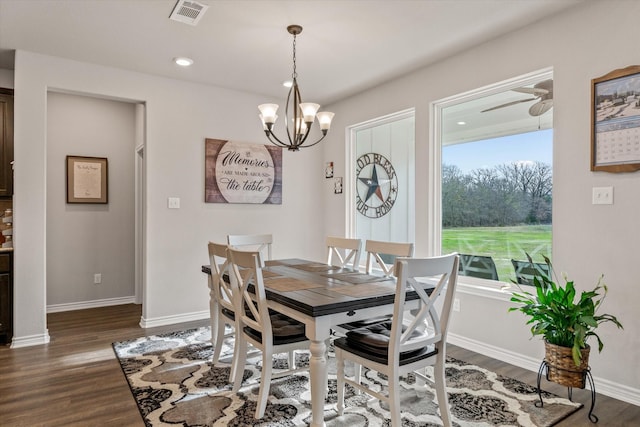 dining space featuring ceiling fan with notable chandelier and dark hardwood / wood-style flooring