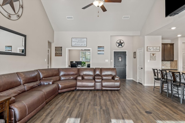 living room with ceiling fan, dark hardwood / wood-style flooring, and high vaulted ceiling