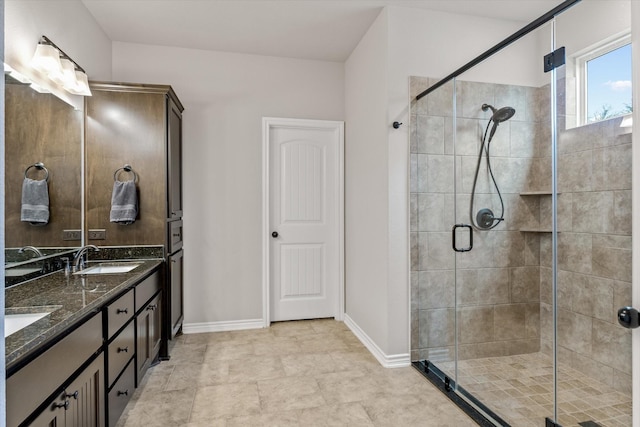 bathroom featuring an enclosed shower and vanity